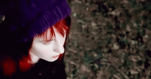 A Woman With Red Hair Is Wearing A Purple Beanie GIF