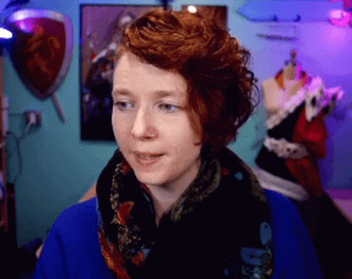 Red Haired Woman Wearing Scarf And Blue Sweater GIF