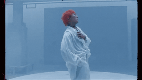 A Woman With Red Hair Is Wearing A White Shirt And A Choker . GIF