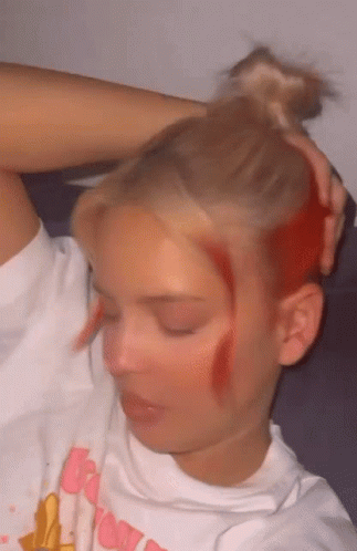 A Woman With Red Hair Is Wearing A White Shirt That Says Barbie GIF