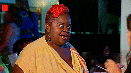 A Woman With Red Hair Is Wearing A Yellow Shirt GIF