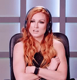 A Woman With Red Hair Is Wearing Headphones And Sitting In A Chair GIF