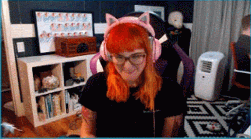 A Woman With Red Hair Is Wearing Pink Cat Ears Headphones GIF