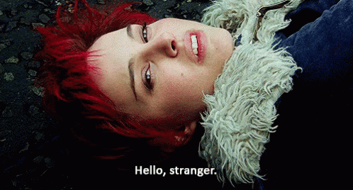 A Woman With Red Hair Laying On The Ground With The Words Hello Stranger Below Her GIF