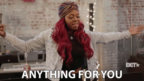 A Woman With Red Hair Says Anything For You In Front Of A Keyboard GIF