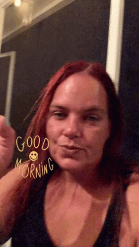 A Woman With Red Hair Says Good Morning With A Smiley Face On Her Face GIF