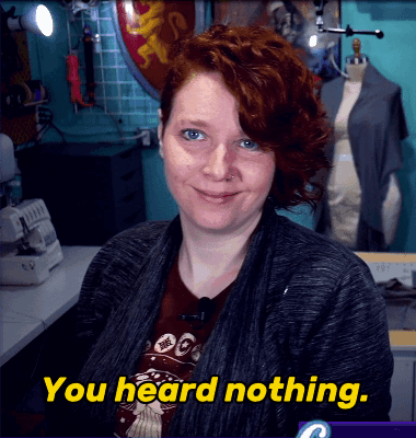 A Woman With Red Hair Says " You Heard Nothing " In Yellow Letters GIF