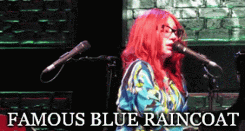 A Woman With Red Hair Singing Into A Microphone With The Words Famous Blue Raincoat Above Her GIF