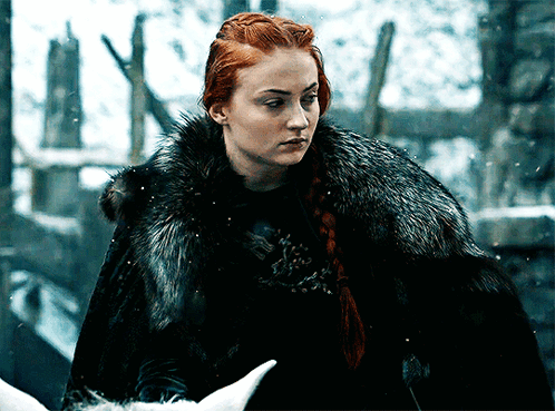 A Woman With Red Hair Wearing A Black Fur Coat GIF