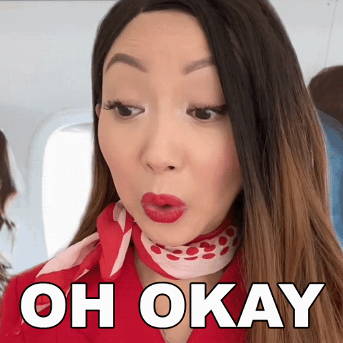 A Woman With Red Lips Is Wearing A Red Scarf Around Her Neck And The Words Oh Okay Above Her GIF