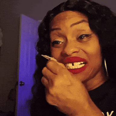 a woman with red lipstick and a black shirt with the letter v on it