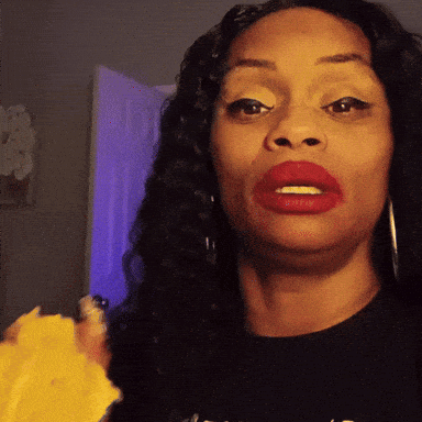 a woman with red lipstick is wearing a black shirt that says ' a ' on the front