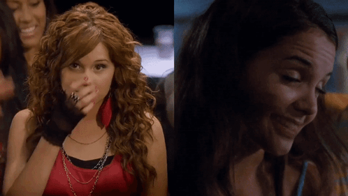 A Woman With Red Nails Is Covering Her Face With Her Hand And Another Woman Is Smiling GIF