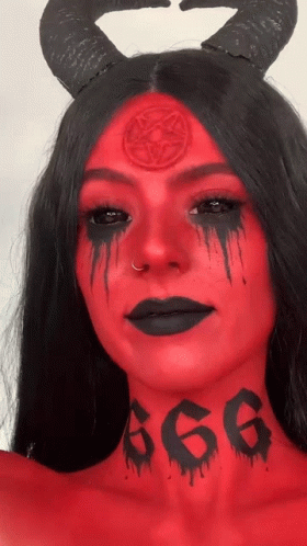A Woman With Red Paint On Her Face Has The Number 666 Tattooed On Her Neck GIF