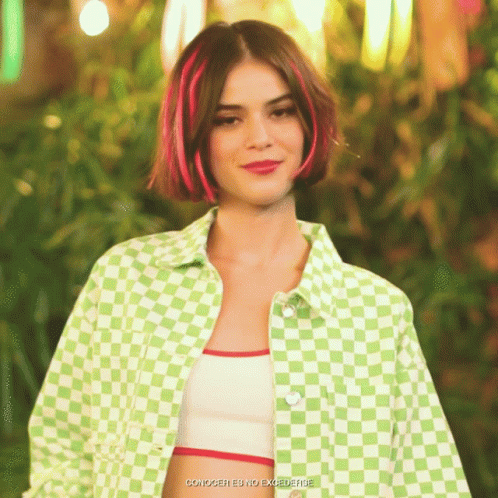 A Woman With Red Streaks In Her Hair Is Wearing A Green Checkered Shirt GIF