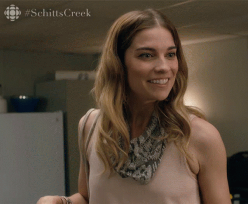 Woman With Schittscreek Text At Bottom GIF