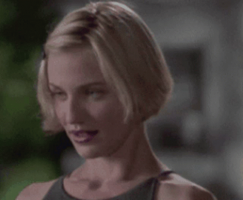 A Woman With Short Blonde Hair And Purple Lips GIF