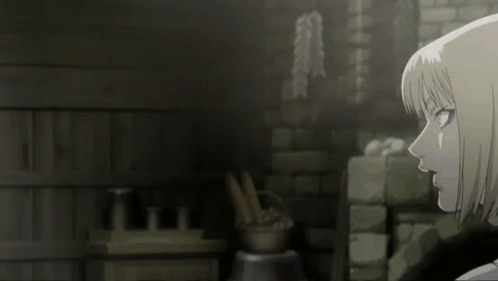 A Woman With Short Blonde Hair Is Standing In Front Of A Brick Wall GIF