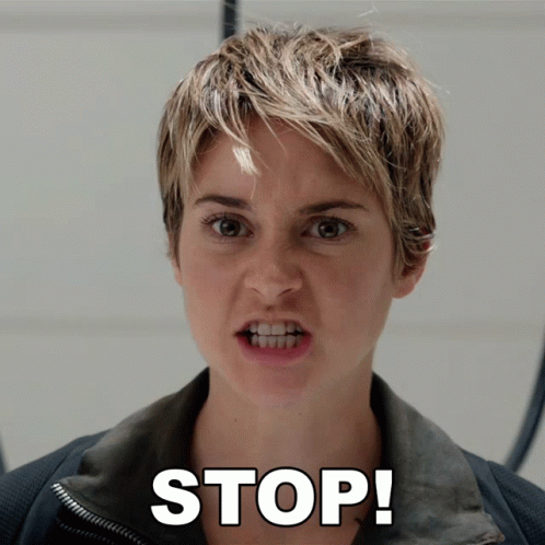 A Woman With Short Hair Is Making A Funny Face And The Word Stop Is Above Her Face GIF