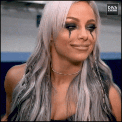 A Woman With Tears Running Down Her Face Is Wearing A Diva Buckle Shirt GIF