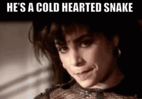 A Woman With The Words He 'S A Cold Hearted Snake Written Above Her GIF