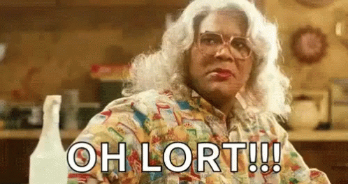 A Woman With White Hair And Glasses Is Sitting At A Table With A Spray Bottle . GIF