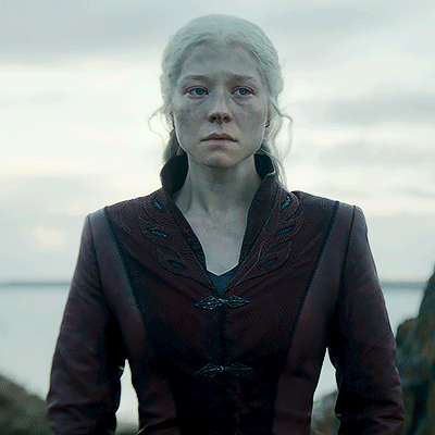 A Woman With White Hair Is Wearing A Burgundy Leather Jacket GIF
