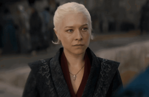 A Woman With White Hair Is Wearing A Necklace And A Black Jacket GIF