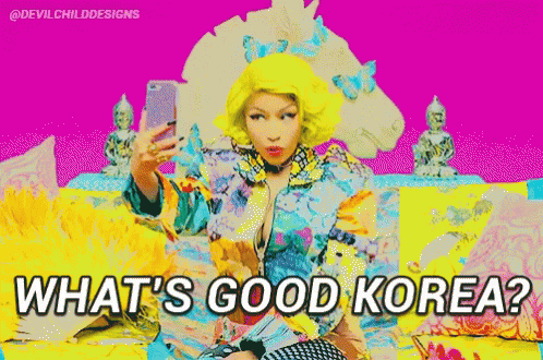 A Woman With Yellow Hair Is Taking A Selfie With The Words What 'S Good Korea Below Her GIF