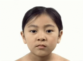 A Woman Without A Shirt Is Looking At The Camera GIF