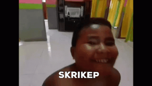 A Woman Without A Shirt Is Smiling And The Word Skrikep Is On The Bottom Of Her Face . GIF
