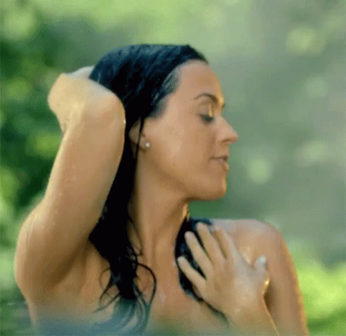 A Woman Without A Shirt Is Taking A Shower GIF