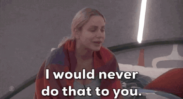 A Woman Wrapped In A Plaid Blanket Says " I Would Never Do That To You " GIF
