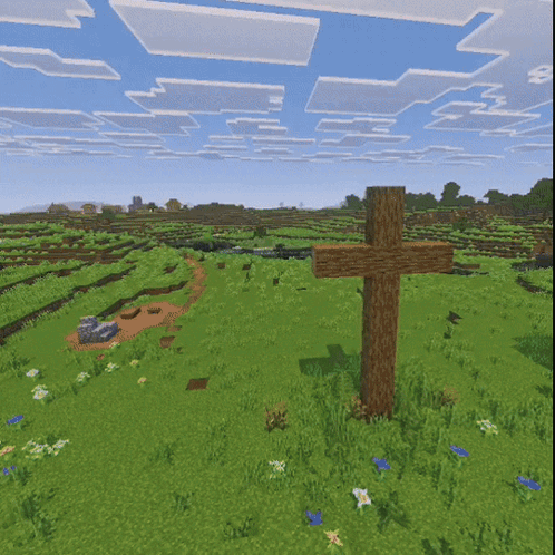 a wooden cross in the middle of a field