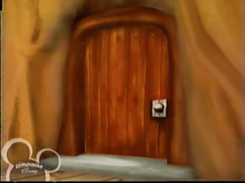 A Wooden Door With A Disney Logo On The Bottom GIF