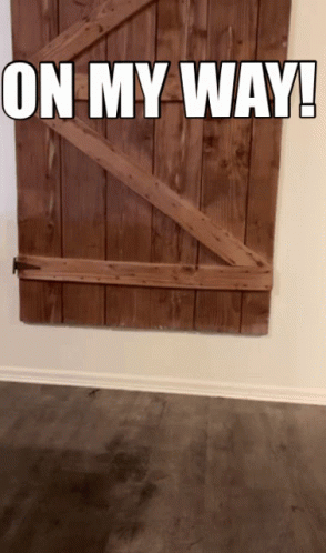 A Wooden Door With The Words " On My Way " Written On It GIF