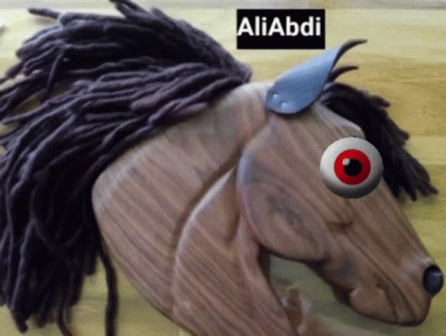 A Wooden Horse With Dreadlocks And A Red Eye Has The Name Aliabdi On The Bottom Right GIF