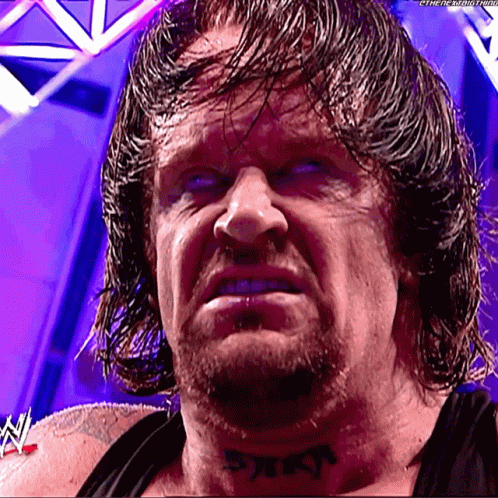 A Wrestler Has A Tattoo On His Neck That Says ' Reign ' GIF