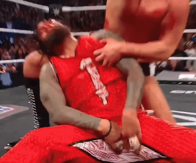 A Wrestler In A Red Outfit With The Number 1 On It GIF