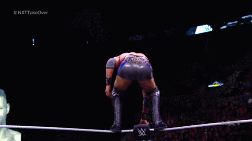 a wrestler in a ring with a sign that says " based "
