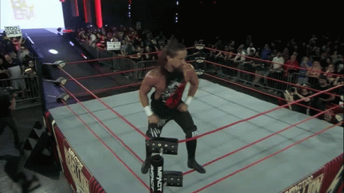 a wrestler in a ring with a sign that says too sweet on it