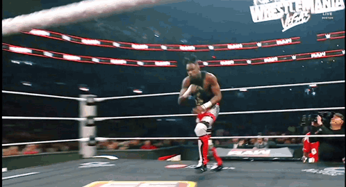 a wrestler in a ring with a sign that says wrestlemania vegas
