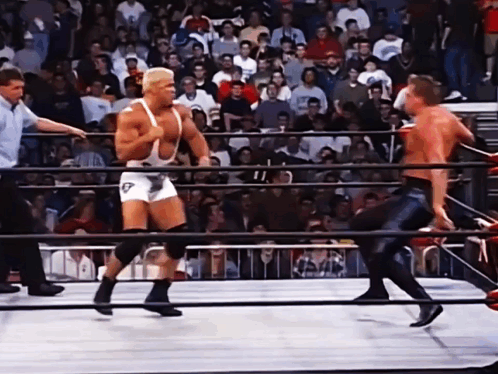 A Wrestler In A White Singlet With The Letter T On It GIF