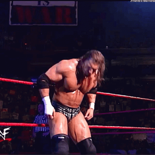 a wrestler in a wrestling ring with a sign that says it 's over