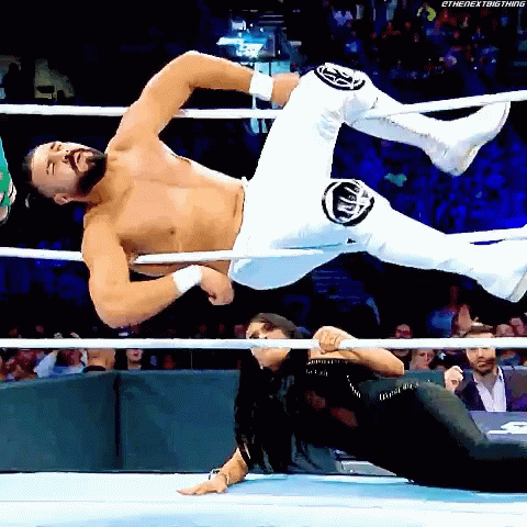 A Wrestler Is Being Lifted In The Air By Another Wrestler GIF