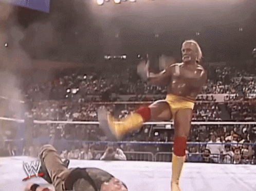 A Wrestler Is Kicking Another Wrestler In The Knee During A Match . GIF