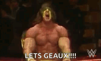 A Wrestler Is Sitting In A Ring With His Mouth Open And The Words `` Lets Geaux '' Written On The Screen . GIF