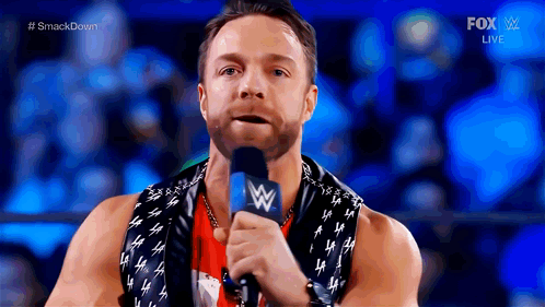 A Wrestler Is Speaking Into A Microphone During A Fox Live Event GIF