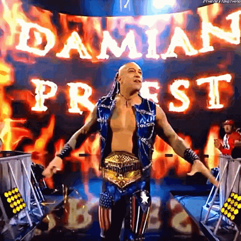 A Wrestler Is Standing In Front Of A Banner That Says Damian Priest On It GIF