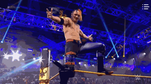 A Wrestler Is Standing On A Rope In A Wrestling Ring With The Hashtag # 2015Live GIF